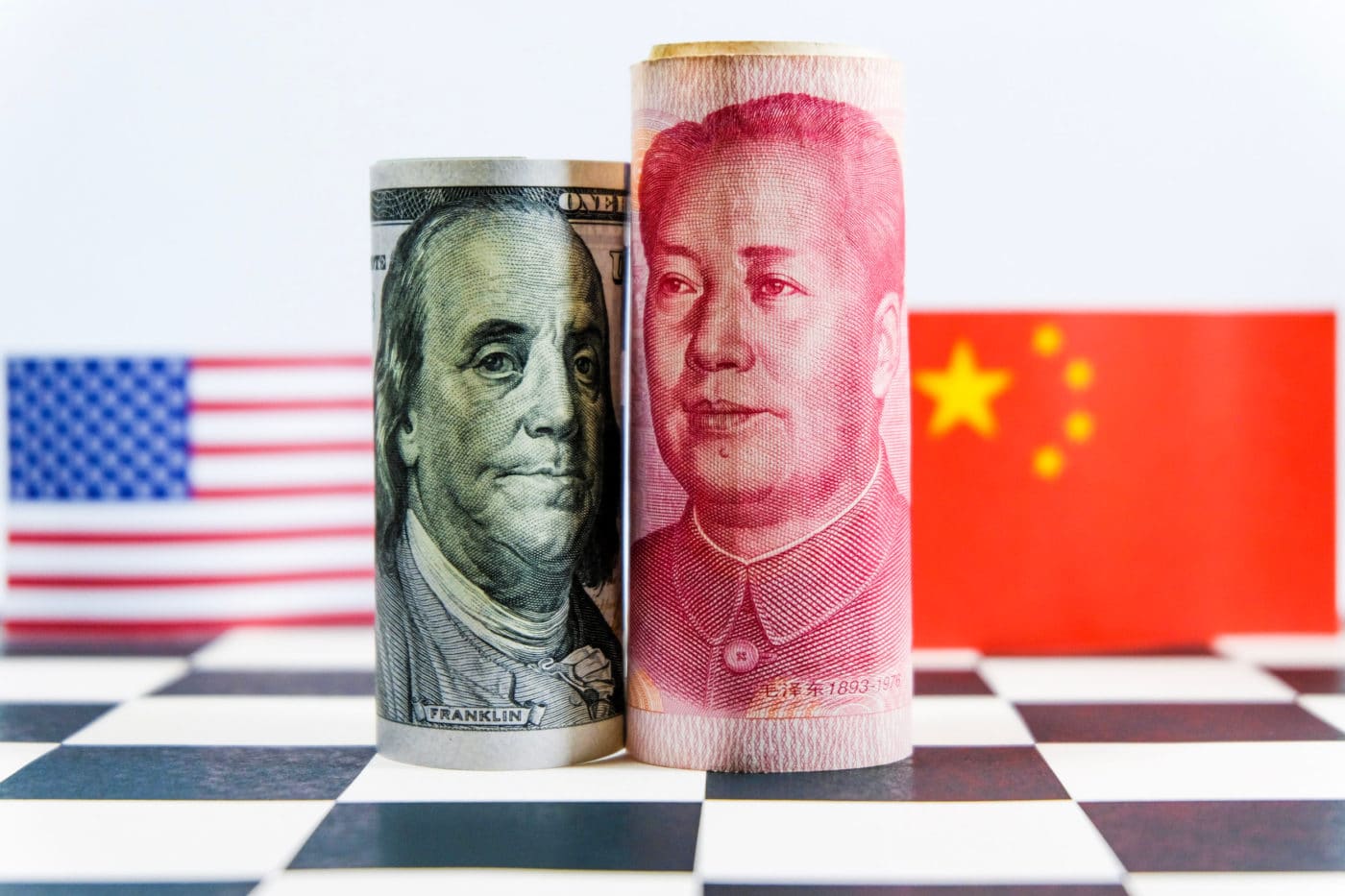 America dollar and Yuan banknote with USA and China flags. Its is symbol for tariff trade war crisis between biggest economic country in the world.