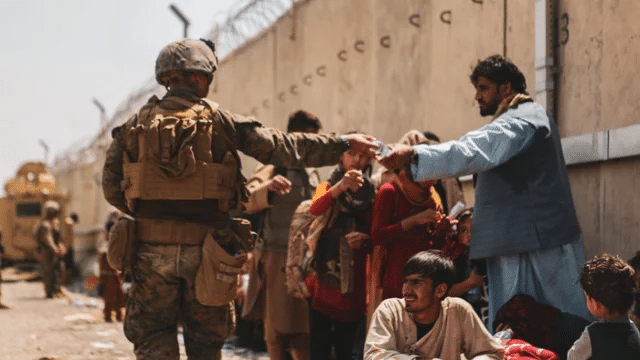 Military personnel guard evacuees in Kabul, Afghanistan