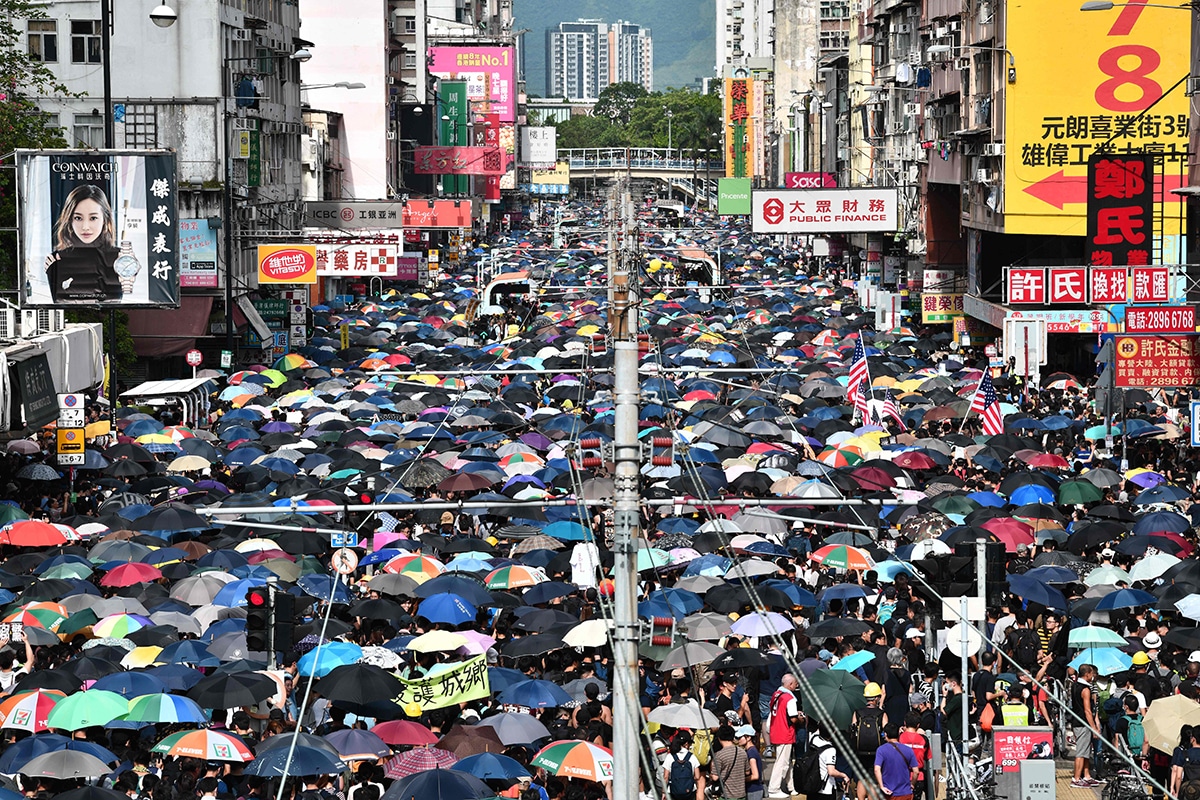 TOPSHOT - Protesters demonstrate in the district of Yuen Long in Hong Kong on July 27, 2019. - Crowds of Hong Kong protesters defied a police ban and began gathering in a town close to the Chinese border to rally against suspected triad gangs who beat up pro-democracy demonstrators there last weekend. (Photo by Anthony WALLACE / AFP)        (Photo credit should read ANTHONY WALLACE/AFP via Getty Images)