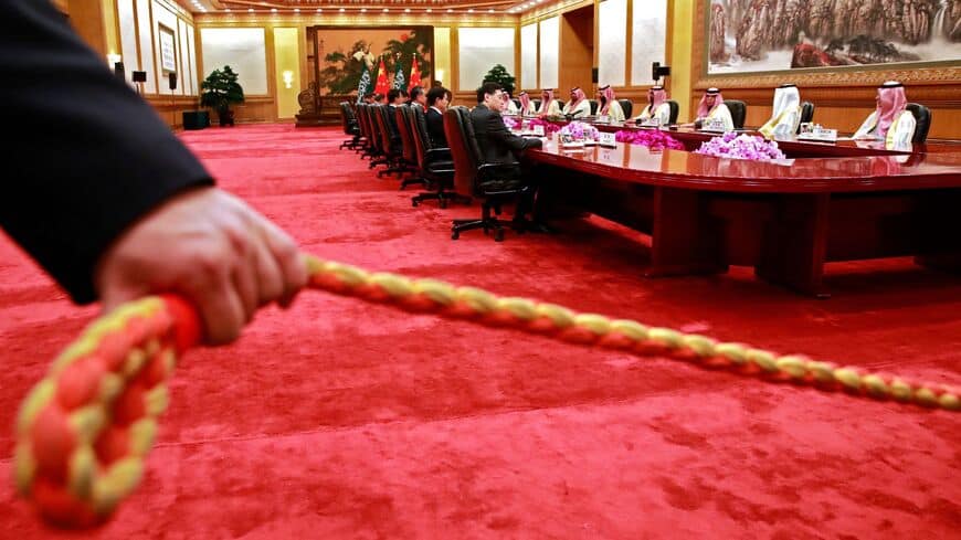 A security officer holds a cordon during the meeting between Saudi Crown Prince Mohammad Bin Salman (5th R) and Chinese President Xi Jinping (not pictured) at the Great Hall of the People in Beijing on February 22, 2019. (Photo by HOW HWEE YOUNG / POOL / AFP)        (Photo credit should read HOW HWEE YOUNG/AFP via Getty Images)