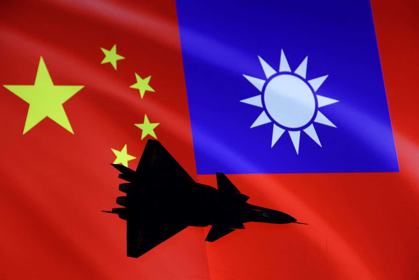 FILE PHOTO: Airplane is seen in front of Chinese and Taiwanese flags in this illustration, August 6, 2022. REUTERS/Dado Ruvic/Illustration