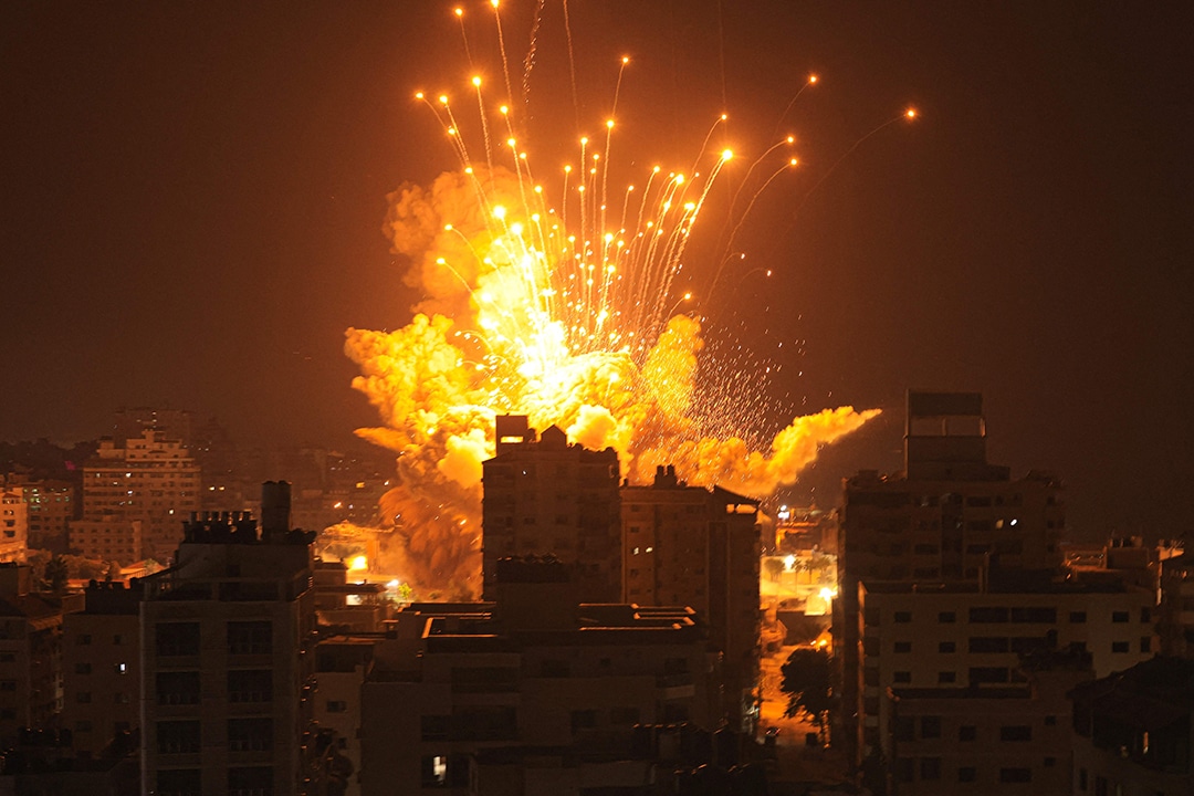A missile explodes in Gaza City during an Israeli air strike on October 8, 2023. srael, reeling from the deadliest attack on its territory in half a century, formally declared war on Hamas Sunday as the conflict's death toll surged close to 1,000 after the Palestinian militant group launched a massive surprise assault from Gaza. (Photo by MAHMUD HAMS / AFP) (Photo by MAHMUD HAMS/AFP via Getty Images)