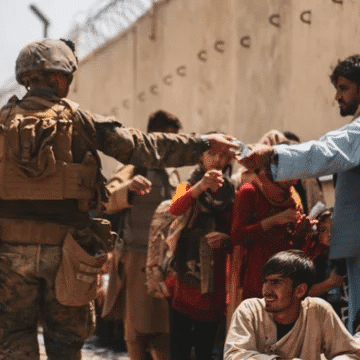 US military personnel guard evacuees in Kabul, Afghanistan