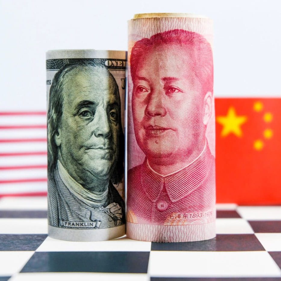 US Dollar and Chinese Yuan currency and national flags